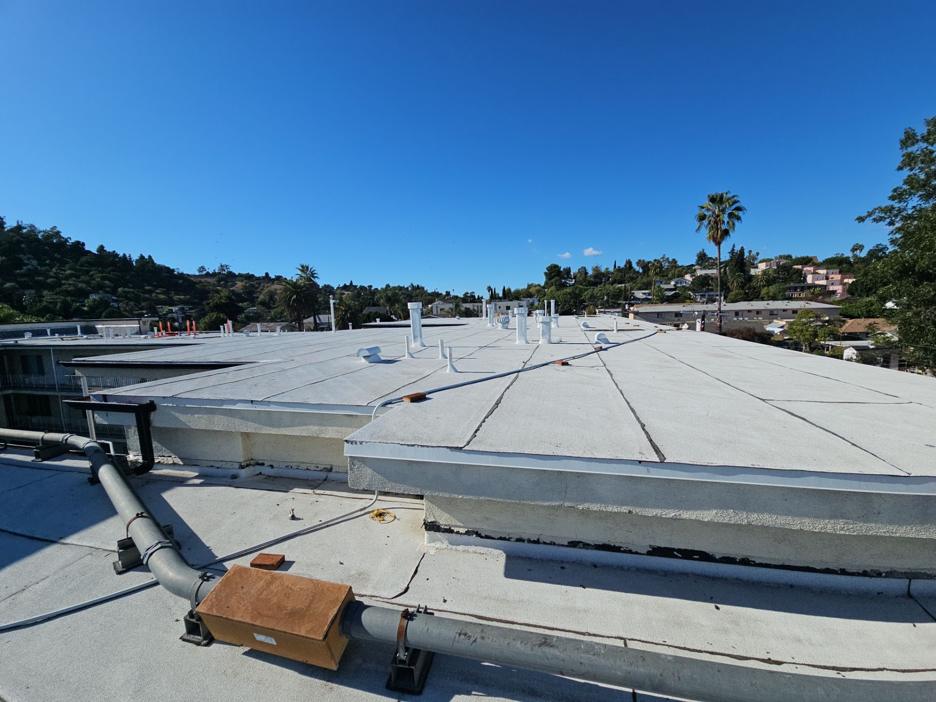 Low-slope commercial roof ready for leak investigation